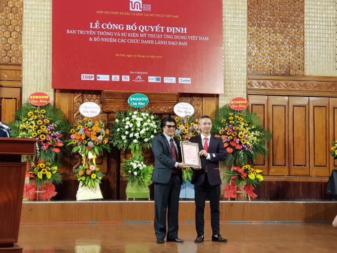 Chủ tịch Hiệp hội Thiết kế mẫu v&agrave; S&aacute;ng tạo Mỹ Thuật Việt Nam L&ecirc; Huy&ecirc;n trao quyết định bổ nhiệm cho T&acirc;n Trưởng Ban truyền th&ocirc;ng &amp; Sự kiện Mỹ thuật ứng dụng Phạm Vĩnh H&agrave;. (Ảnh: Minh Anh).