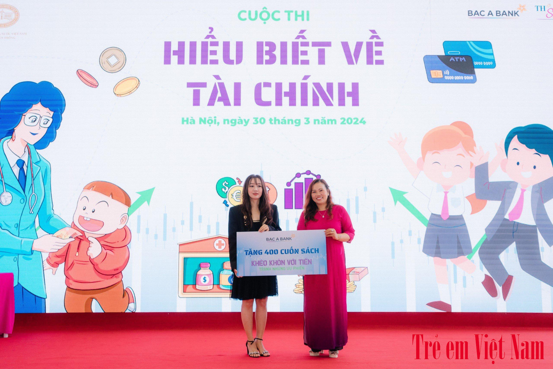 Bà Vũ Thu Hằng (b&ecirc;n phải) - Đại di&ecirc;̣n BACABank trao tặng 400 cu&ocirc;́n truy&ecirc;̣n tranh "Khéo kh&ocirc;n với ti&ecirc;̀n, tránh những ưu phi&ecirc;̀n" cho trường TH School.